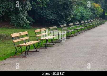 Numerose panchine vicino al laghetto nel Parco di Battersea durante la stagione autunnale di Londoon Foto Stock