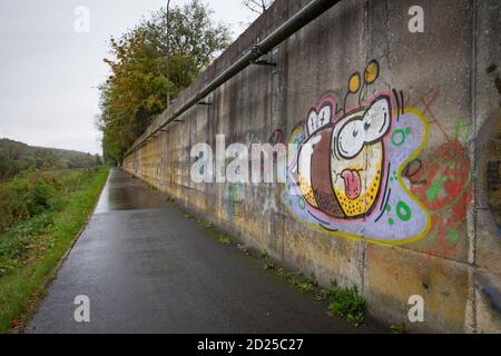 graffiti su un muro della pista ciclabile della valle della Ruhr a Wetter-Wengern, Ruhr Area, Nord Reno-Westfalia, Germania. Graffiti auf einer Mauer am Ruhrtalr Foto Stock