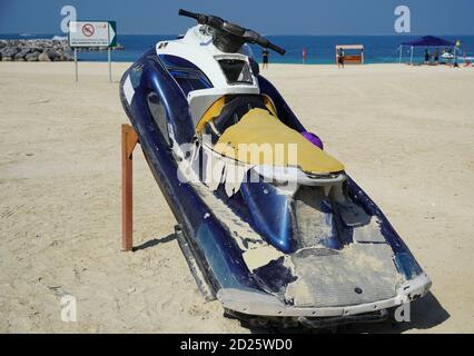 Dirty Old Jet Ski parcheggiato sulla spiaggia della stagione delle feste. Old Jet Skis sulla spiaggia su Trailer in legno. Blue and White Jet Ski - Dubai Emirati Arabi Uniti Gennaio 2020 Foto Stock