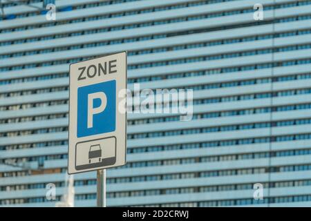 Parcheggio vicino sullo sfondo di un edificio a più piani in una giornata di sole. Spazio di copia Foto Stock