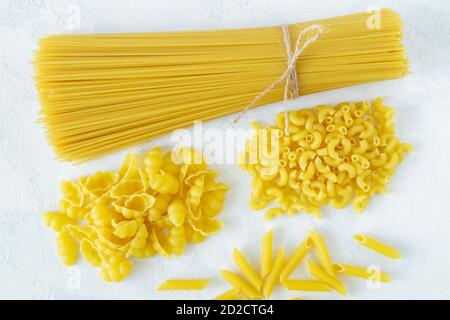 Asciugare diversi tipi di pasta su uno sfondo chiaro Foto Stock