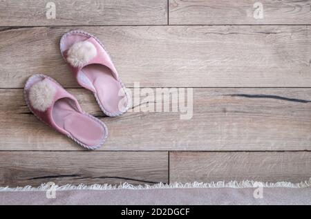 Scarpe rosa fatte in casa sul pavimento di legno. Foto Stock
