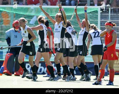 Germany field hockey team celebrate victory over China after their Champions Trophy Women's Field Hockey Tournament final match in Amstelveen, the Netherlands, July 16, 2006. From 2nd left: Germany's Fanny Rinne, who scored the winning goal, Anke Kuehn, Katharina Scholz and Kerstin Hoyer (8). At right is China's Shuang Li. REUTERS/Paul Vreeker (NETHERLANDS)