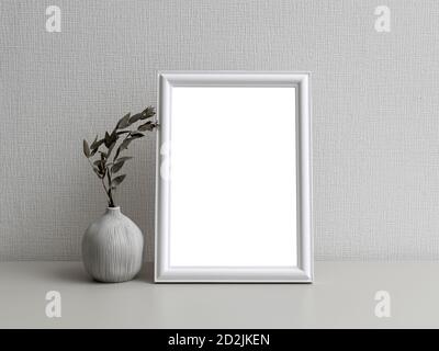 Una cornice fotografica semplice di fronte a una parete bianca Foto Stock