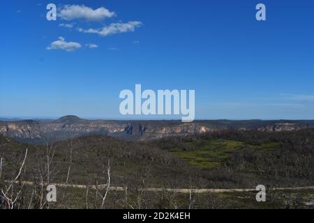 vista delle scogliere, della flora e della ricrescita dagli alberi e dalle piante bruciati Foto Stock