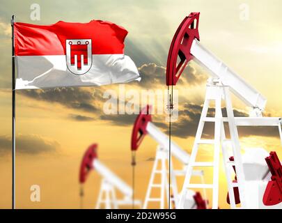 Le piattaforme petrolifere si fanno sullo sfondo del cielo colorato e di un flagpole con la bandiera di Vorarlberg. Il concetto di produzione di petrolio, minerali, sviluppo di Foto Stock