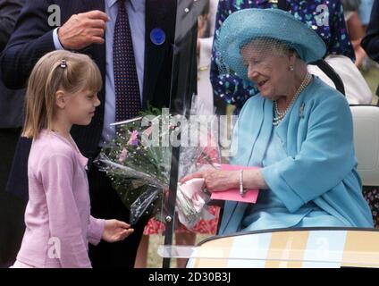 La Regina Elisabetta della Gran Bretagna, la Regina Madre riceve un mazzo di fiori da un giovane ammiratore reale, durante una visita al Sandringham Flower Show. Foto Stock