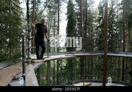 Treehotel co-founder Kent Lindvall stands on the scaffolding around The Nest on the construction site of Treehotel in the Swedish village of Harads, July 5, 2010. A lofty new hotel concept is set to open in a remote village in northern Sweden, which aims to elevate the simple treehouse into a world-class destination for design-conscious travellers. Treehotel, located in Harads about 60 km south of the Arctic Circle, will consist of four rooms when it opens on July 17th: The Cabin, The Blue Cone, The Nest and The Mirrorcube. Picture taken July 5, 2010.     To match Reuters Life! SWEDEN-TREEHOTE