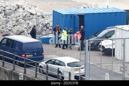 Un gruppo di persone pensavano di essere i migranti sono portate a riva dalla forza di frontiera ufficiali presso il porto di Dover nel Kent dopo un piccolo incidente in barca nel canale. Foto Stock