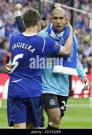 Il Phil Jagielka di Everton (a sinistra) festeggia con il compagno di squadra Tim Howard (a destra) dopo il fischio finale. Foto Stock