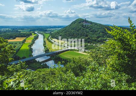 Monumento dell'Imperatore Guglielmo in cima a Wittekindsberg e il fiume Weser sulla sinistra. Vicino alla città di porta Westfalica, Nord Reno Westfalia, Germania. Foto Stock