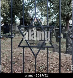 Braunschweig, Germania, 27 agosto 2020: Porta chiusa di ferro con una stella forgiata di Davide davanti allo storico cimitero ebraico di Braunschweig, Germ Foto Stock