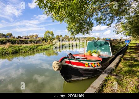 Narrowboat ormeggiato sulla riva del ramo Bruce del Kennett e Avon Canal a Great Bedwyn, un villaggio nel Wiltshire orientale, Inghilterra meridionale Foto Stock