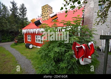 La Casa di Natale vicino Akureyri nel nord dell'Islanda. I vestiti di Babbo Natale sono visti appesi sulla linea di lavaggio all'esterno. Caramelle e dolci adornano il tetto. Foto Stock