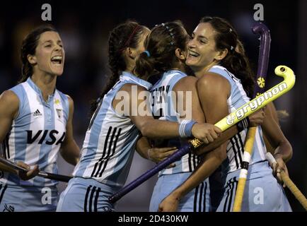 Members of the Argentine women's field hockey team, from left, Ines Arredondo, Agustina Soledad Garcia, Cecilia Rognoni and Luciana Aymar, celebrate after Rognoni scored her team's second goal against Australia during their women's field hockey Champions Trophy match, at the Jockey Club in Rosario, Argentina, November 14, 2004. Argentina defeated Australia 3-2 to clinch the bronze medal. REUTERS/Enrique Marcarian  EM