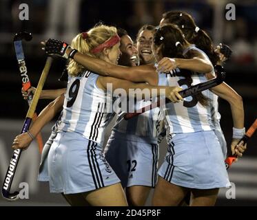 Members of the Argentine women's field hockey team, from left, Vanina Oneto (9), Alejandra Gulla, Mariana Diaz Oliva, Magdalena Aicega (3), and Maria de la Paz Hernandez, celebrate after their teammate, Alejandra Gulla scored her team's first goal against Australia during their women's field hockey Champions Trophy match, played at the Jockey Club in the Argentina's city of Rosario, November 9, 2004. REUTERS/Enrique Marcarian  EM