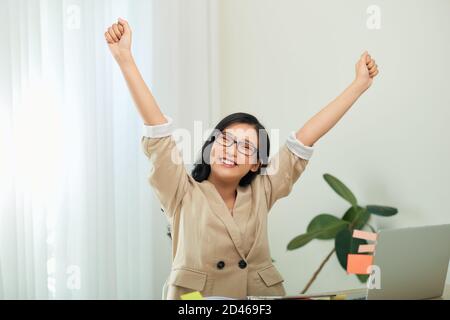 Head shot piacevole felice giovane donna freelance che lavora sul computer a casa. Foto Stock