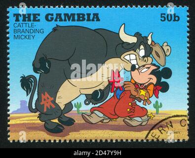 GAMBIA - CIRCA 1995: Francobollo stampato da Gambia, mostra Cattlebranding Topolino, circa 1995 Foto Stock