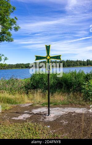 Antica pattée storica a croce di ferro con simbolismo masonico in un boschetto di fronte al Castello di Läckö sul lago Vänern, Västergötland, Svezia. Foto Stock