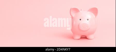 Banco di piggy su sfondo rosa. Concetto di risparmio e budget. Immagine con spazio di copia. Foto Stock