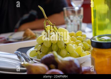 Fichi interi purpuri freschi, ficus carica e uva con vitamine e calorie. Alimentazione adeguata per vegan, vegetariano, dieta. Stile di vita sano Foto Stock