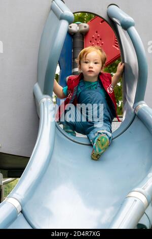 Giocare sul parco giochi in tempo piovoso Foto Stock