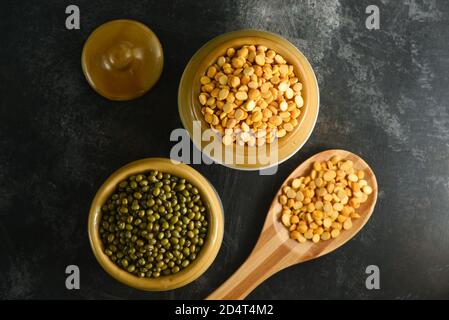 Varie fonti di fagioli proteici vegetali, lenticchie, piselli, ceci, fagioli mungo in ciotole. Impulsi indiani non cotti, lenticchie, riso sana dieta equilibrata Foto Stock