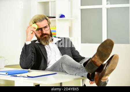 Hipster giocare a tennis palla. Burnout e mancanza di idee. Concetto di crisi. Uomo imprenditore di successo formale abito da lavoro seduta interni ufficio. Business manager rilassante. Lavoro in ufficio. Concetto aziendale. Foto Stock