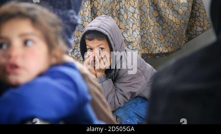 bambino stanco, viso triste, bambini malati in attesa di entrare in clinica Foto Stock