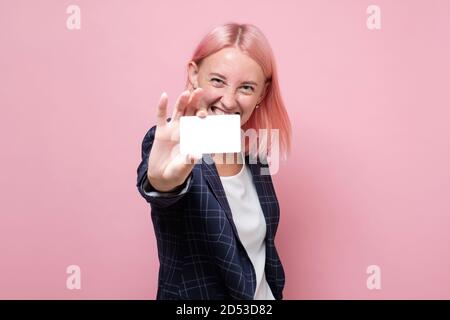 donna d'affari in tuta che tiene la sua carta da visita vuota Foto Stock