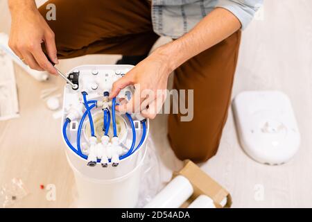 L'impianto idraulico installa un filtro dell'acqua. Filtro dell'acqua. Foto Stock