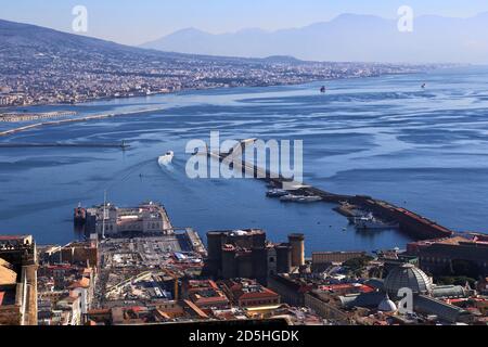 Vista panoramica di Napoli da Castel Sant Elmo con, in primo piano, Castel nuovo e la Stazione Marittima, contro il profilo del V. Foto Stock