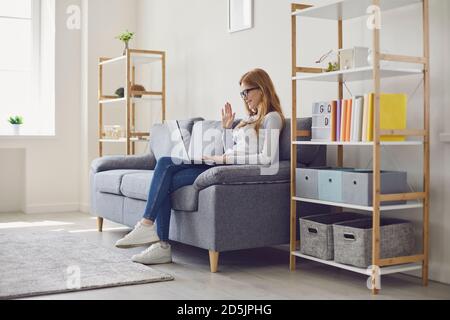Lavoro online o formazione remota. Donna giovane seria che studia o conduce la conferenza di affari di fotoricettore a casa Foto Stock