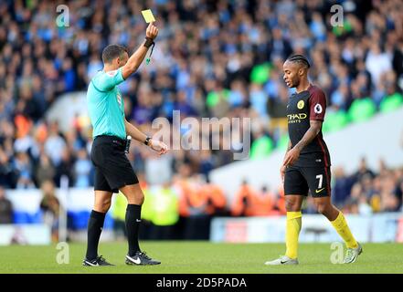 L'arbitro Andre Marriner mostra il Raheem Sterling di Manchester City la carta gialla. Foto Stock