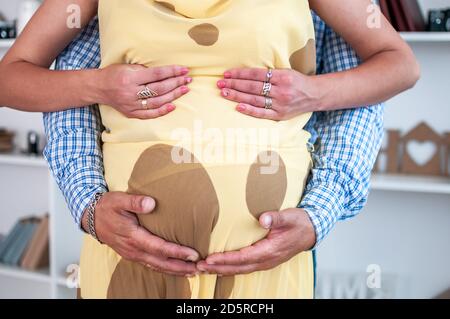 mani di uomo e donna sul ventre incinta Foto Stock