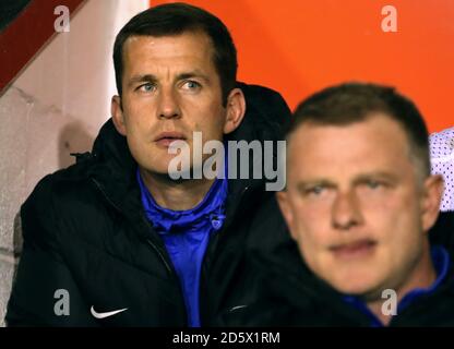 Coventry City's Colin Doyle sulla panchina guardando il gioco dietro Il City Manager di Coventry Mark Robins dopo aver aiutato i giocatori a scaldarsi come parte del suo allenatore distintivi Foto Stock