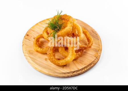 anelli di cipolla su un piatto di legno su fondo bianco Foto Stock