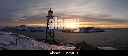 Faro allo stadio di calcio Henningsvaer durante l'alba sulle isole Lofoten in Norvegia. Foto Stock