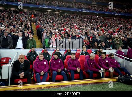 Il manager della città di Manchester Pep Guardiola (a sinistra), l'assistente del pullman Domenec Torrent (seconda a sinistra) e l'assistente del pullman Mikel Arteta (terza a sinistra) nel dugout davanti ai tifosi di Liverpool Foto Stock