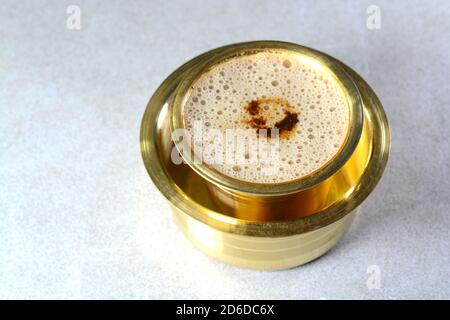 Caffè indiano filtro servito in una tazza di ottone e in un piatto Foto Stock