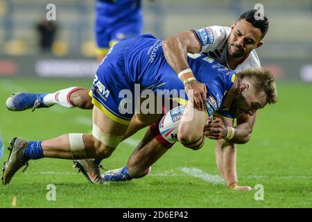 Matt Davies di Warrington Wolves fermato da Bevan francese di Guerrieri di Wigan Foto Stock