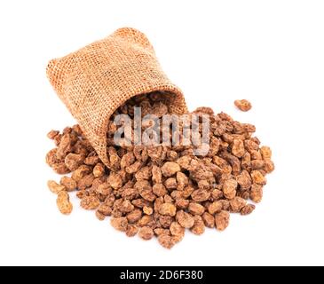 Tigernut in piccolo sacco a scamone, isolato su sfondo bianco. Dadi Chufa o dadi tigre. Foto Stock