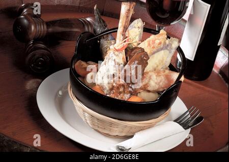 Stinco di agnello brasato in una pentola con impasto di verdure fritte Foto Stock