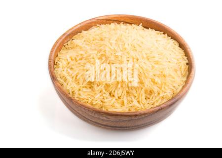 Ciotola di legno con riso dorato grezzo isolato su sfondo bianco. Vista laterale, primo piano. Foto Stock