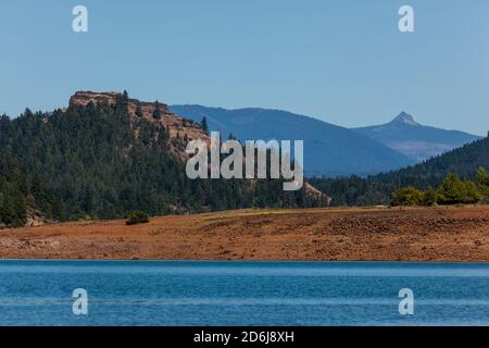 Guardando attraverso la superficie del lago Lost Creek fino a Stewart State Park sul lungofiume con Needle Eye Rock e. Union Peak nel Cascade Mountain Rang Foto Stock