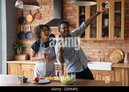 Happy biracial coppia hanno divertimento cucina cibo in cucina Foto Stock