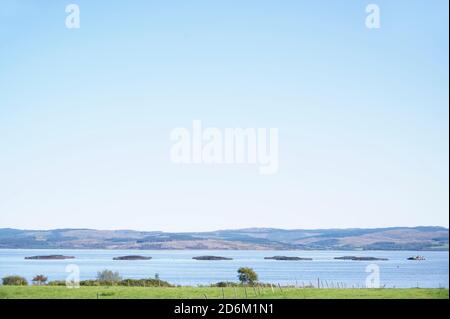 Pesce fattoria salmone reti rotonde in ambiente naturale Loch awe Arygll e Bute Scotland Foto Stock