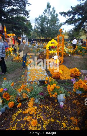 I marigolds conosciuti in Messico, come 'il fiore dei morti' decorano tombe a Patzcuaro durante il giorno dei morti, quando le famiglie ricordano i loro cari. Foto Stock