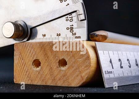 Un goniometro e un righello metallico per misurare gli angoli in  un'officina di Falegnameria. Accessori per la misurazione e il disegno in  un negozio di carpenteria. Luogo di lavoro - lavori Foto stock - Alamy