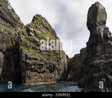 Le scogliere, le pile di mare e gli archi a Vestmanna, una delle grandi attrazioni delle Isole Faroe l'isola di Streymoy, una delle due grandi isole di Foto Stock